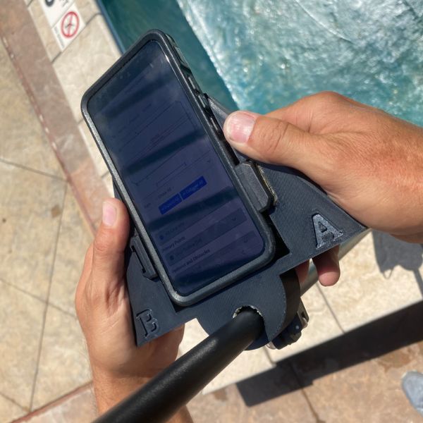 two-hand-device-pictured-with-mobile-phone-in-it close up of two handed device with phone